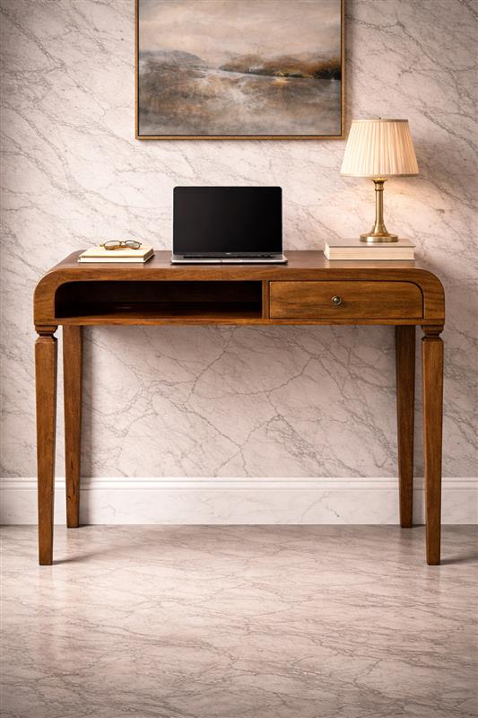 Elegant wooden desk with laptop and lamp.